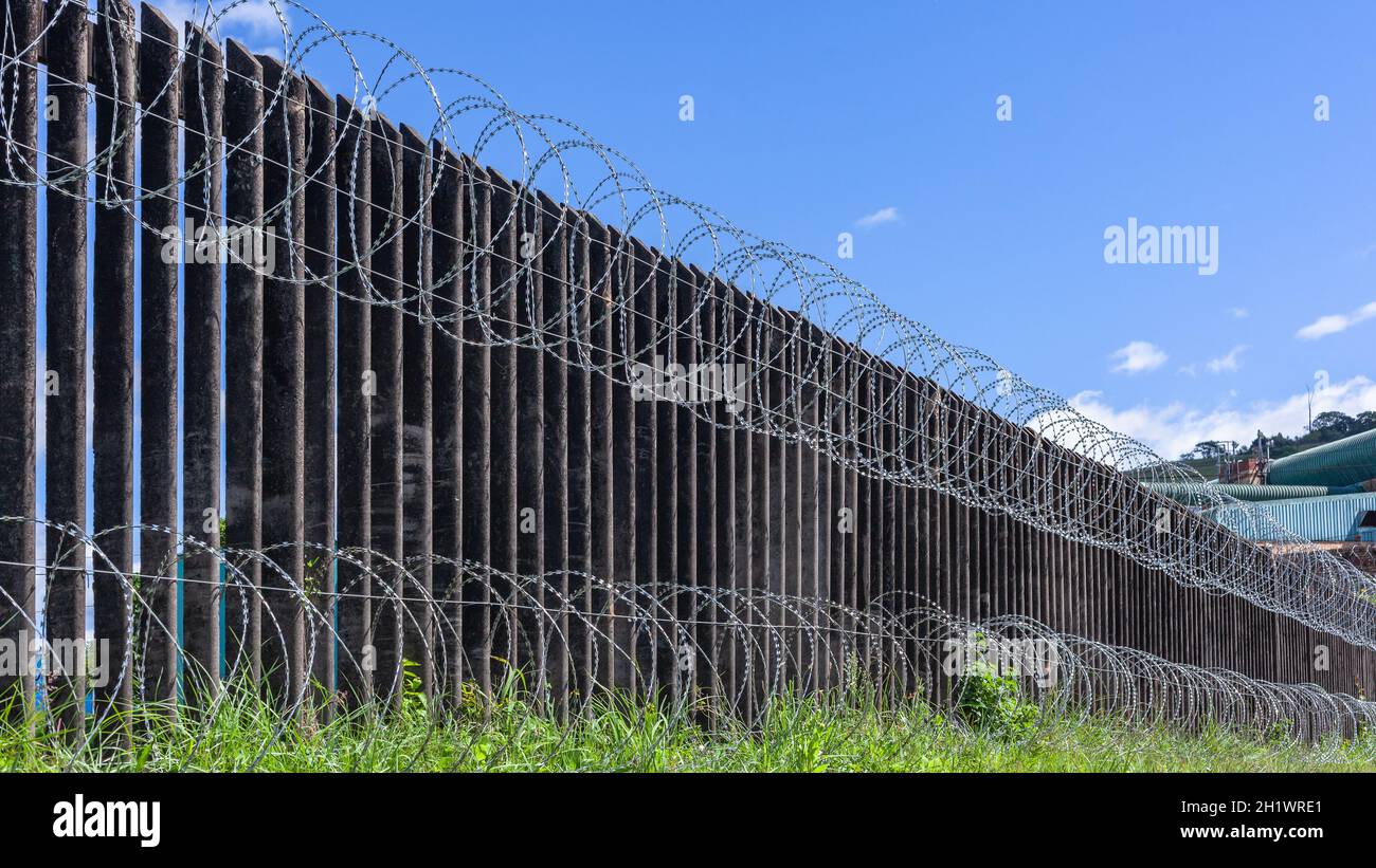 Razor barbed wire installed on boundary fence of factory property for