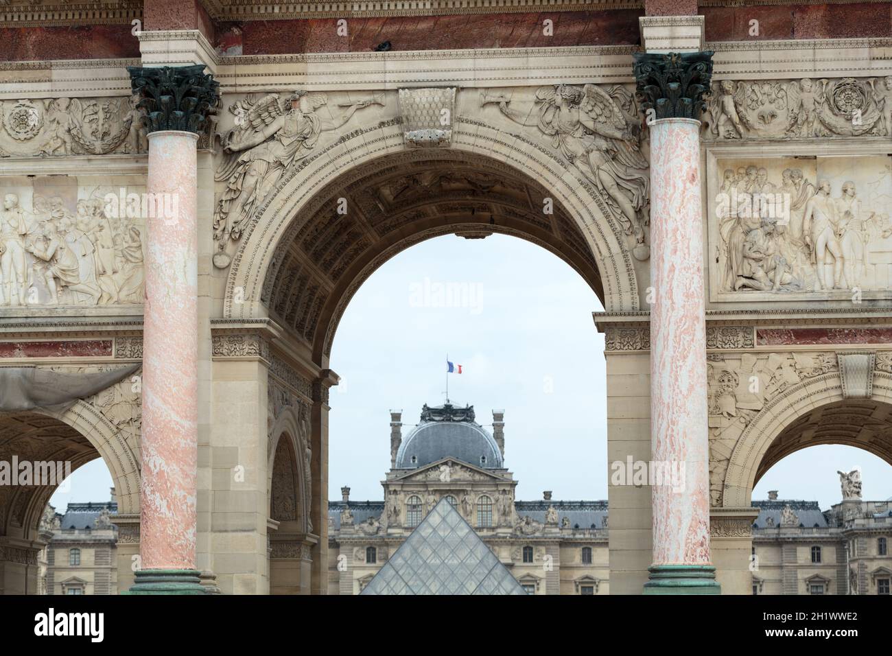 Paris - Triumphal Arch and Glass Pyramid in Louvre. Louvre is one of the  biggest Museum in the world; receiving more than 8 million visitors each  year Stock Photo - Alamy