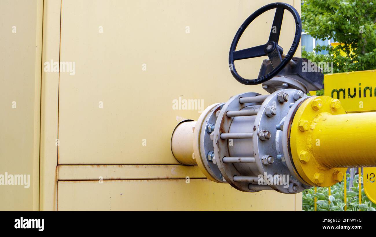 Yellow gas pipe with a tap. Oil pipeline fittings in the oil and gas