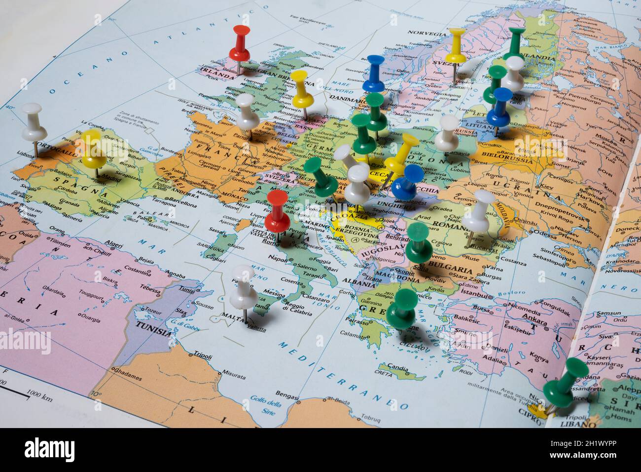European capitals marked with colored pins on an atlas Stock Photo