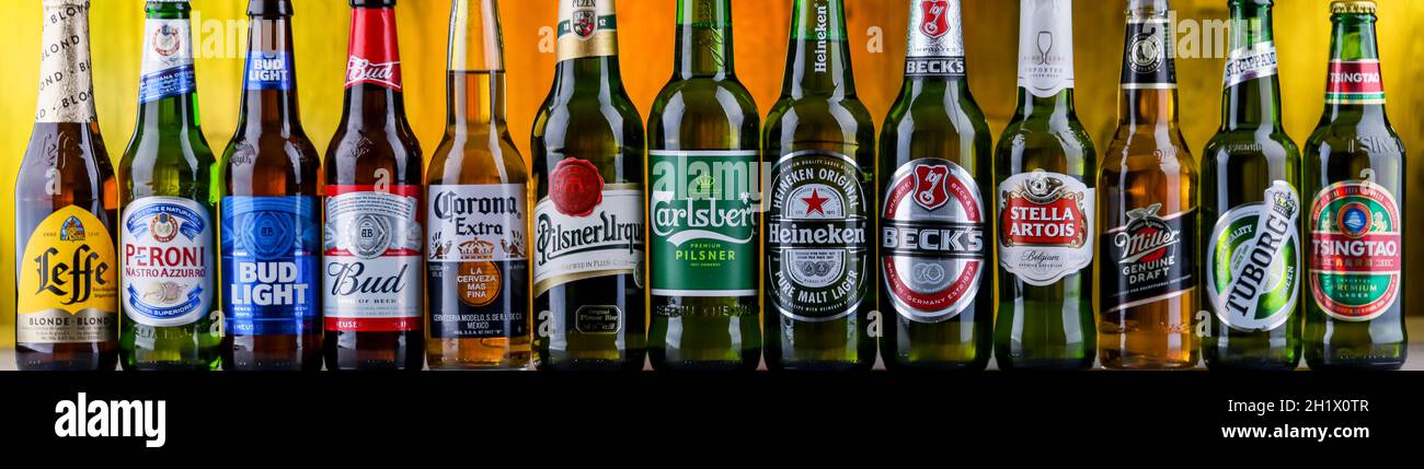 POZNAN, POL - AUG 06, 2021: Bottles of famous global beer brands including Heineken, Becks, Bud, Miller, Corona, Stella Artois and Carlsberg Stock Photo