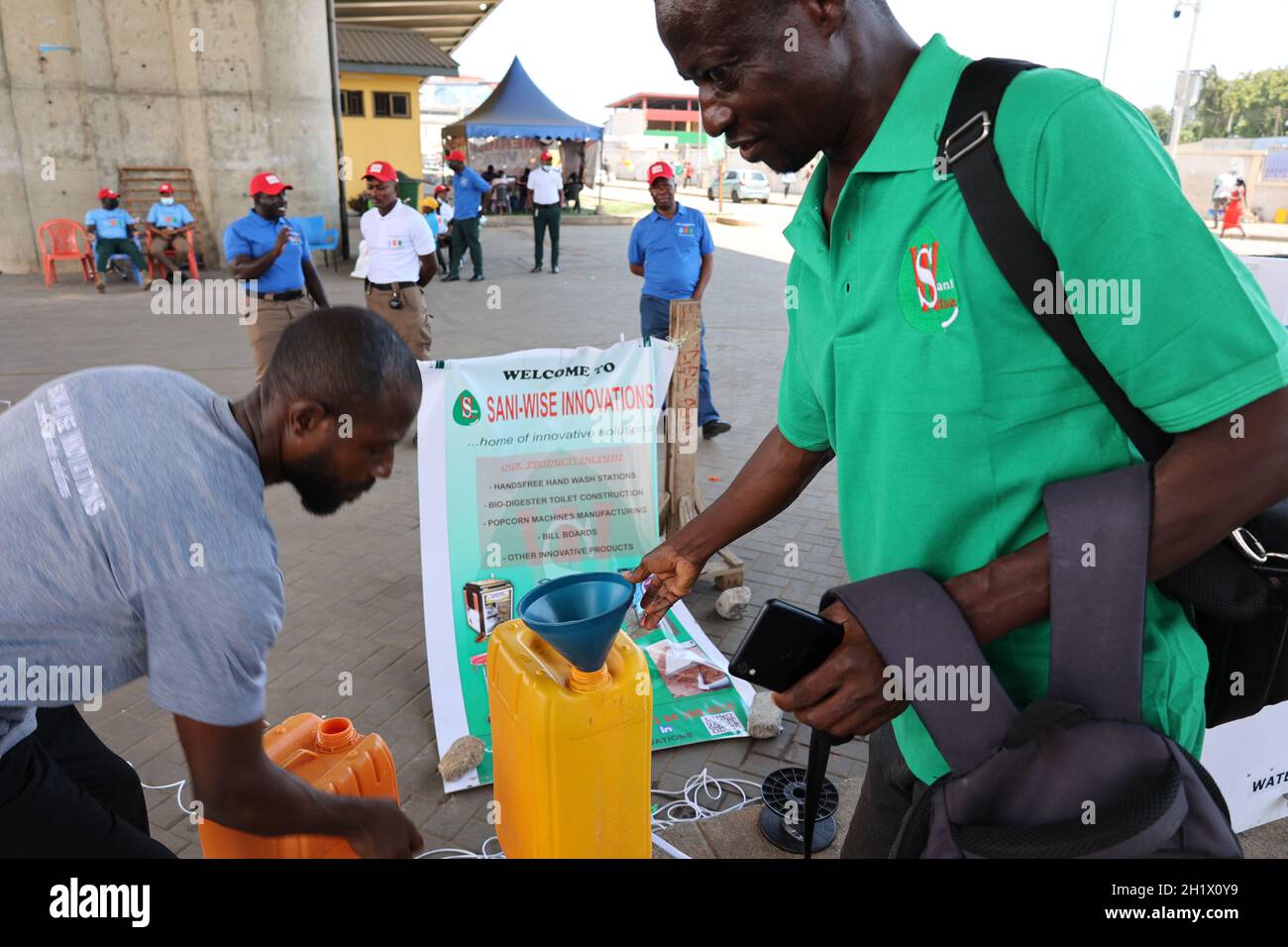 Accra, Ghana. 15th Oct, 2021. A worker pours water into a water tank of