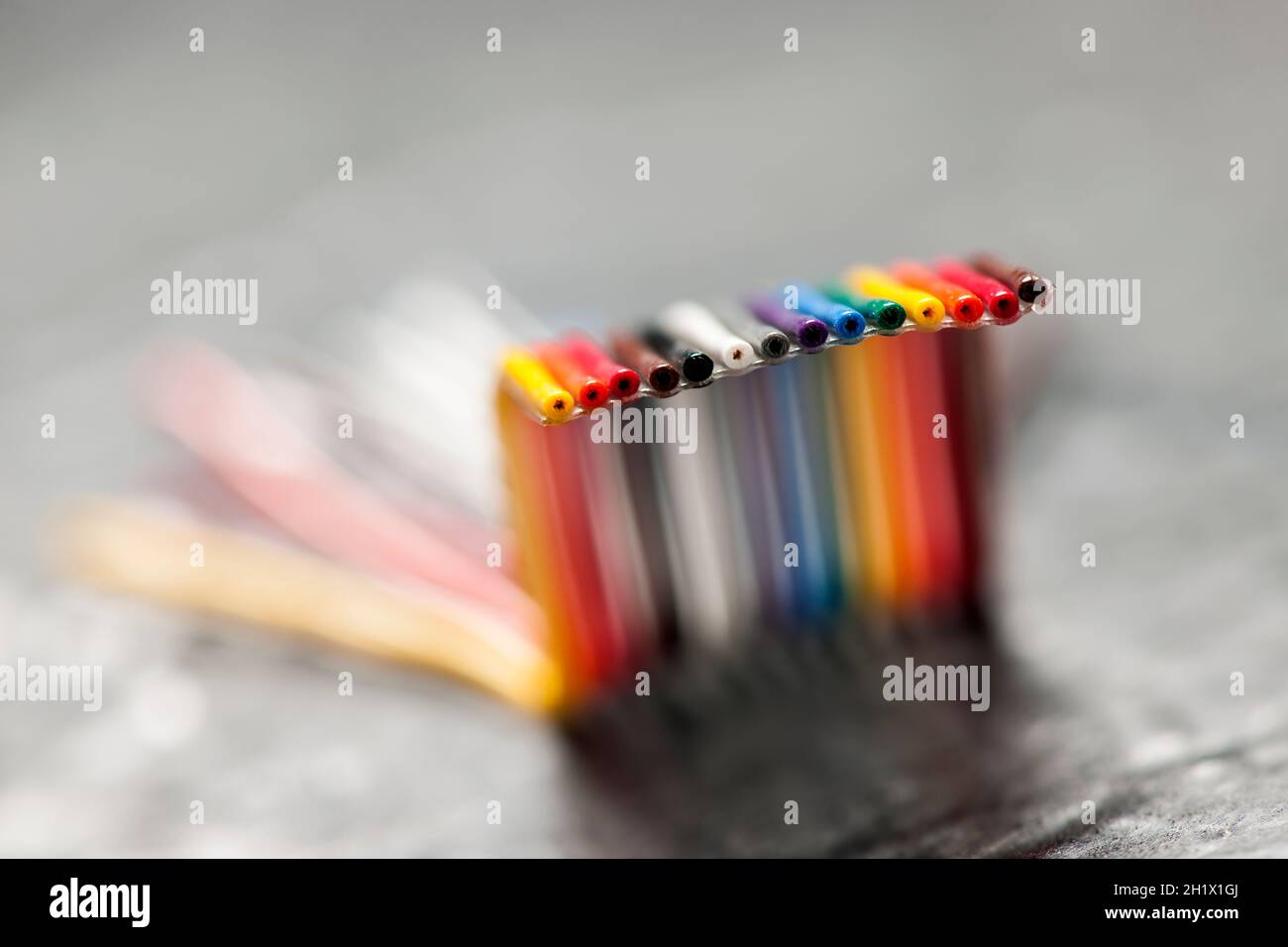 Extreme closeup of a short, bent and colorful computer ribbon cable on