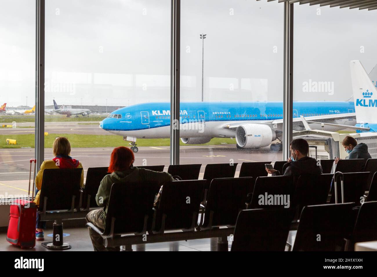 Amsterdam, Netherlands - May 21, 2021: Passengers with KLM Royal Dutch Airlines airplane at Amsterdam Schiphol airport (AMS) in the Netherlands. Stock Photo