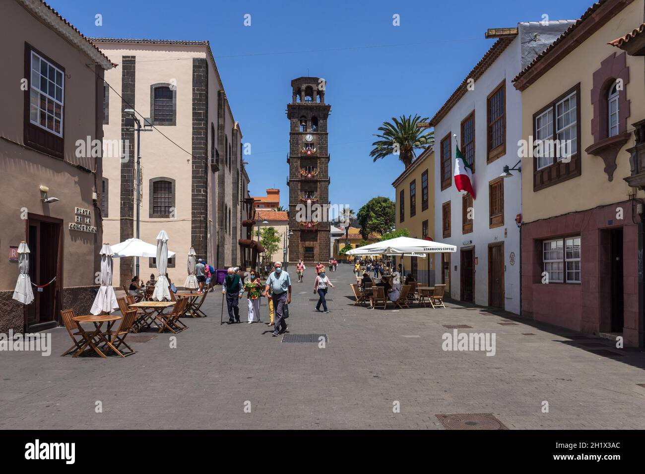 SAN CRISTOBAL DE LA LAGUNA, CANARY ISLANDS, TENERIFE - JULY 03, 2021: Street in the historic city center. In the background, the bell tower of the Chu Stock Photo