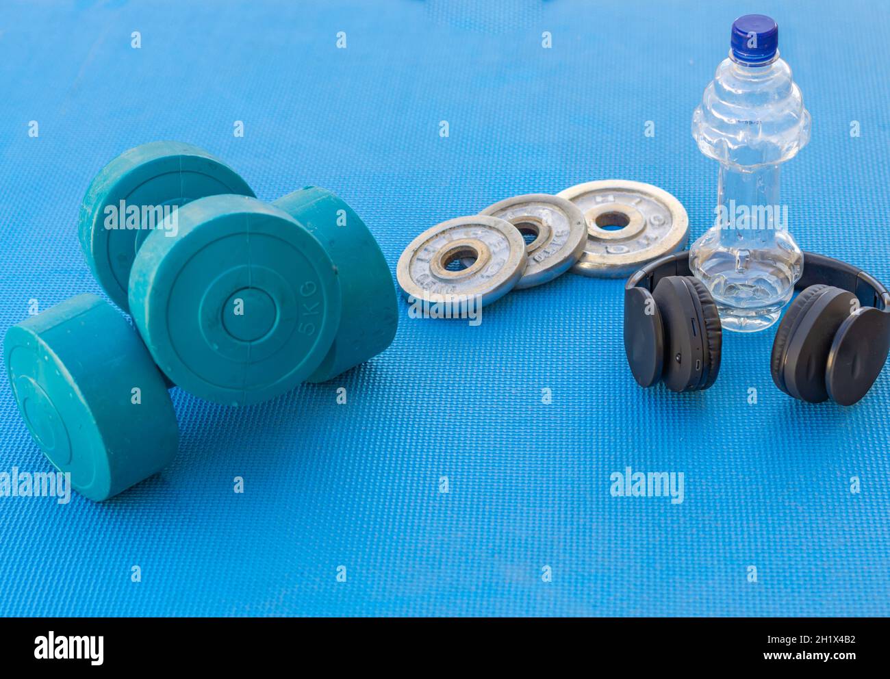 weights and fitness training equipment on the gym floor Stock Photo