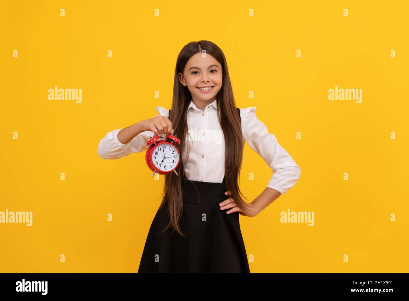 last chance. punctual teen girl checking time. cheerful child with alarm clock. Stock Photo