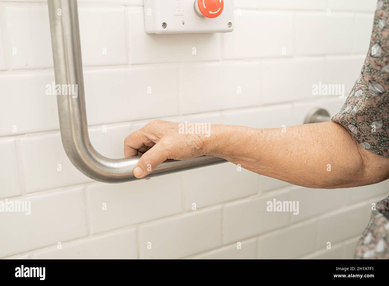 Asian senior or elderly old lady woman patient use toilet bathroom handle security in nursing hospital ward, healthy strong medical concept. Stock Photo