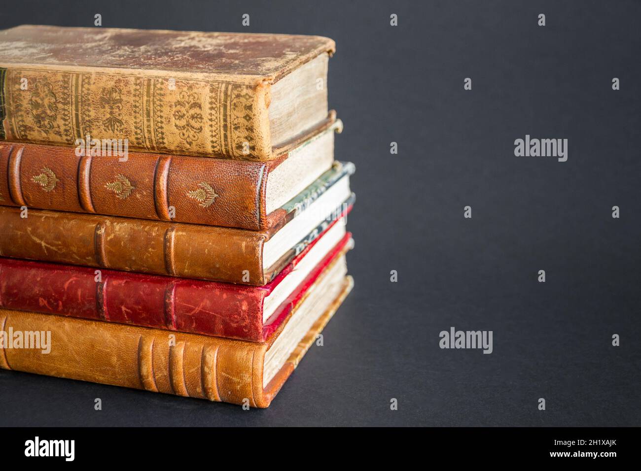 Stack of old books isolated on dark background Stock Photo