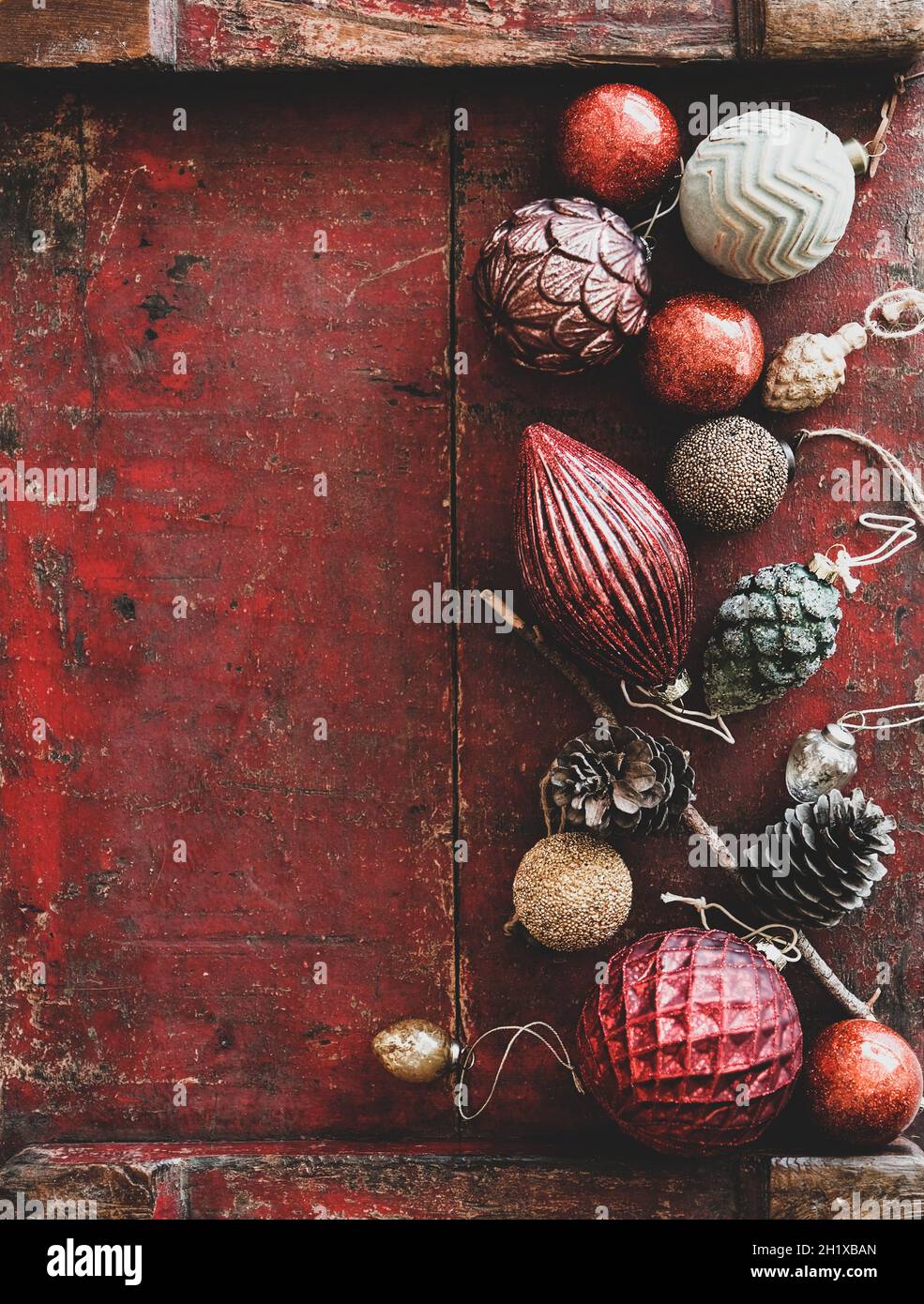 Christmas decoration toys and balls over dark red rustic wooden background Stock Photo