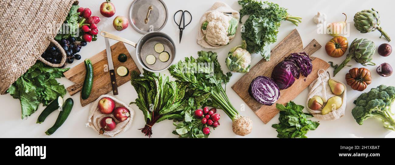 Table with fresh seasonal vegetables, greens, fruit from grocery market Stock Photo