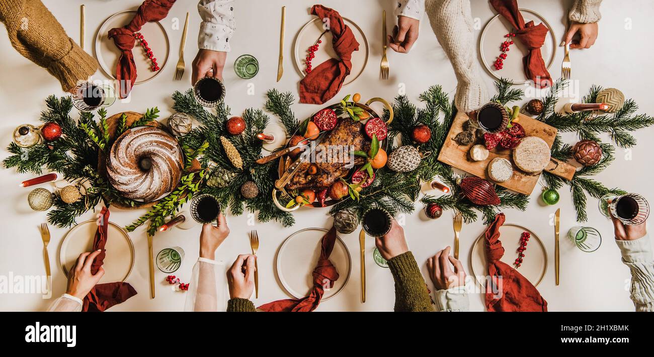 Flat-lay of Festive Christmas table setting and celebrating people Stock Photo