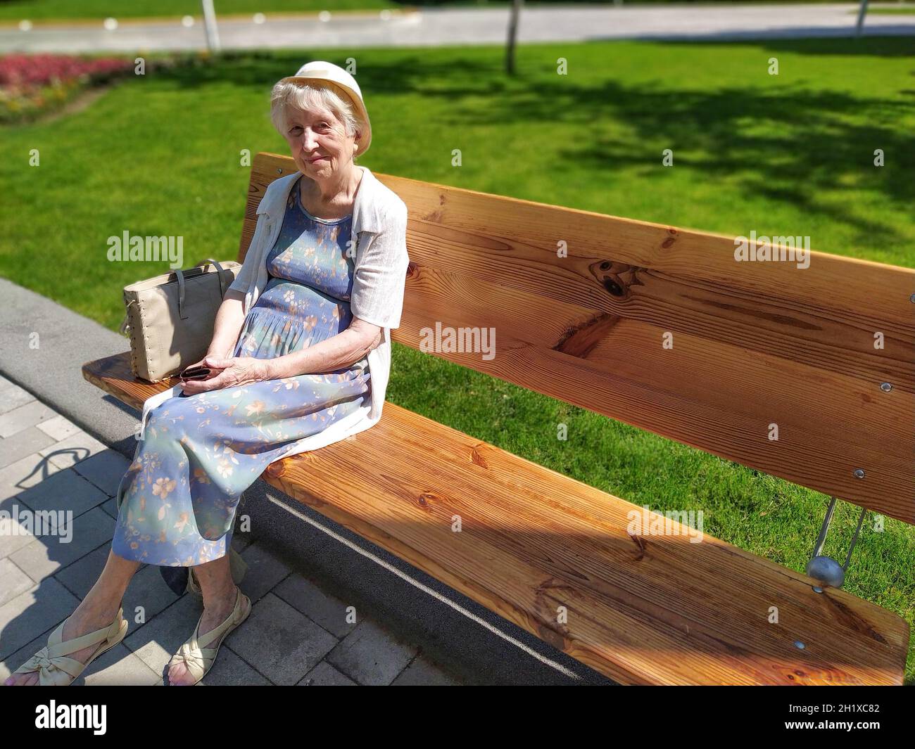 Senior elderly women sitting on bench in park at summer Stock Photo - Alamy