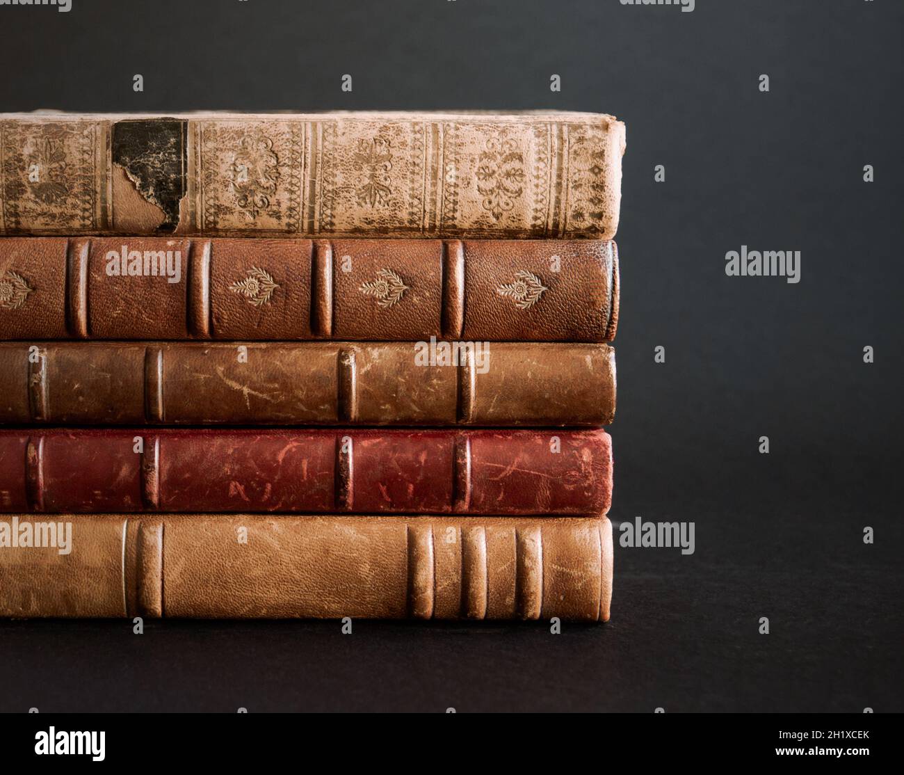Stack of old books isolated on black background Stock Photo - Alamy