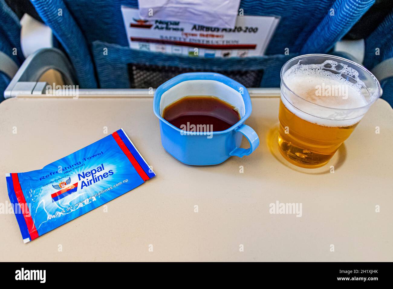 Plastic cup on the table in the plane during the flight. alcohol  consumption on board Stock Photo by ©Hugo1313 274175914