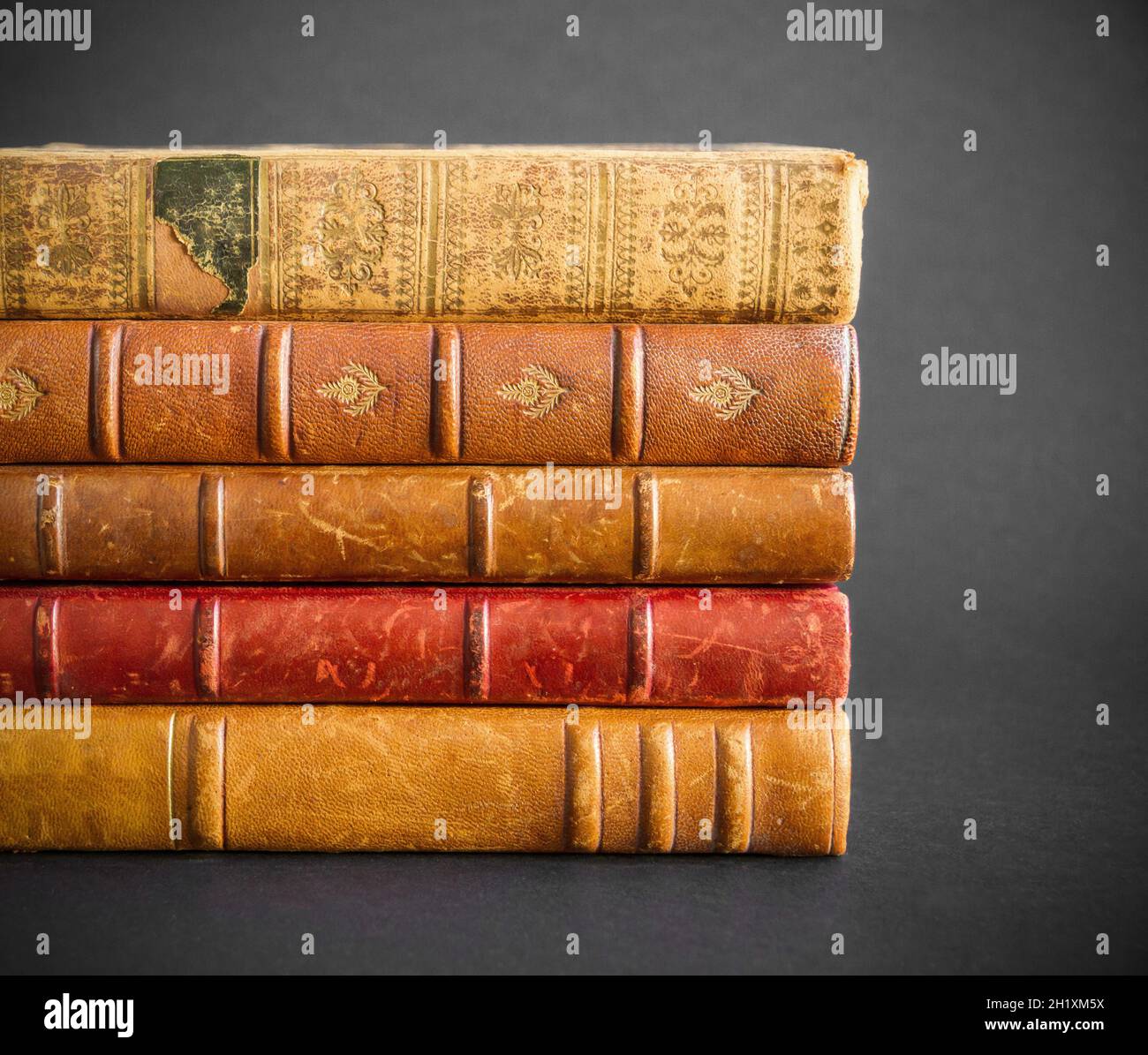 Stack of old books isolated on dark background Stock Photo