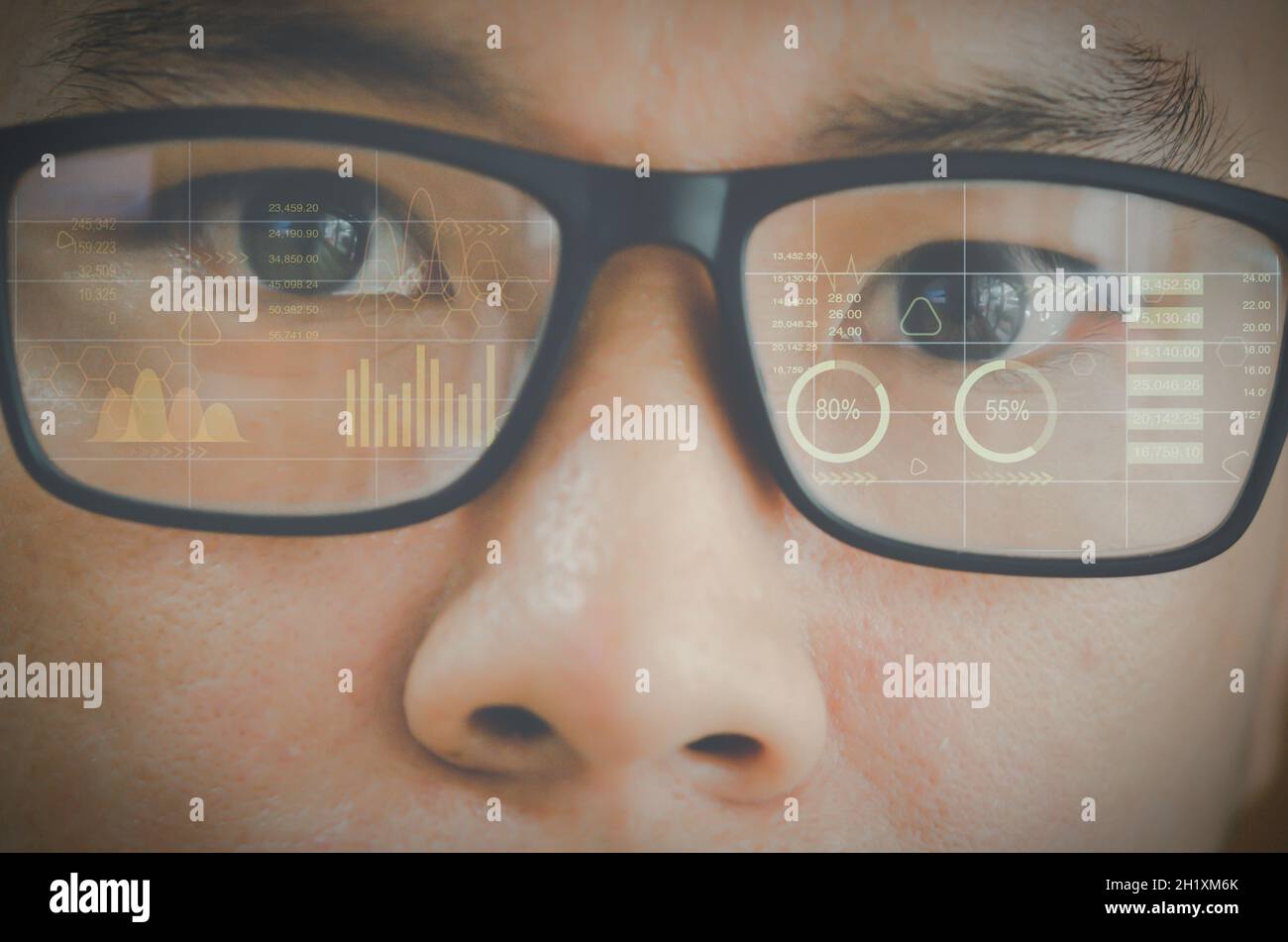 Close up eye in glasses with futuristic holographic interface to display data.future technology