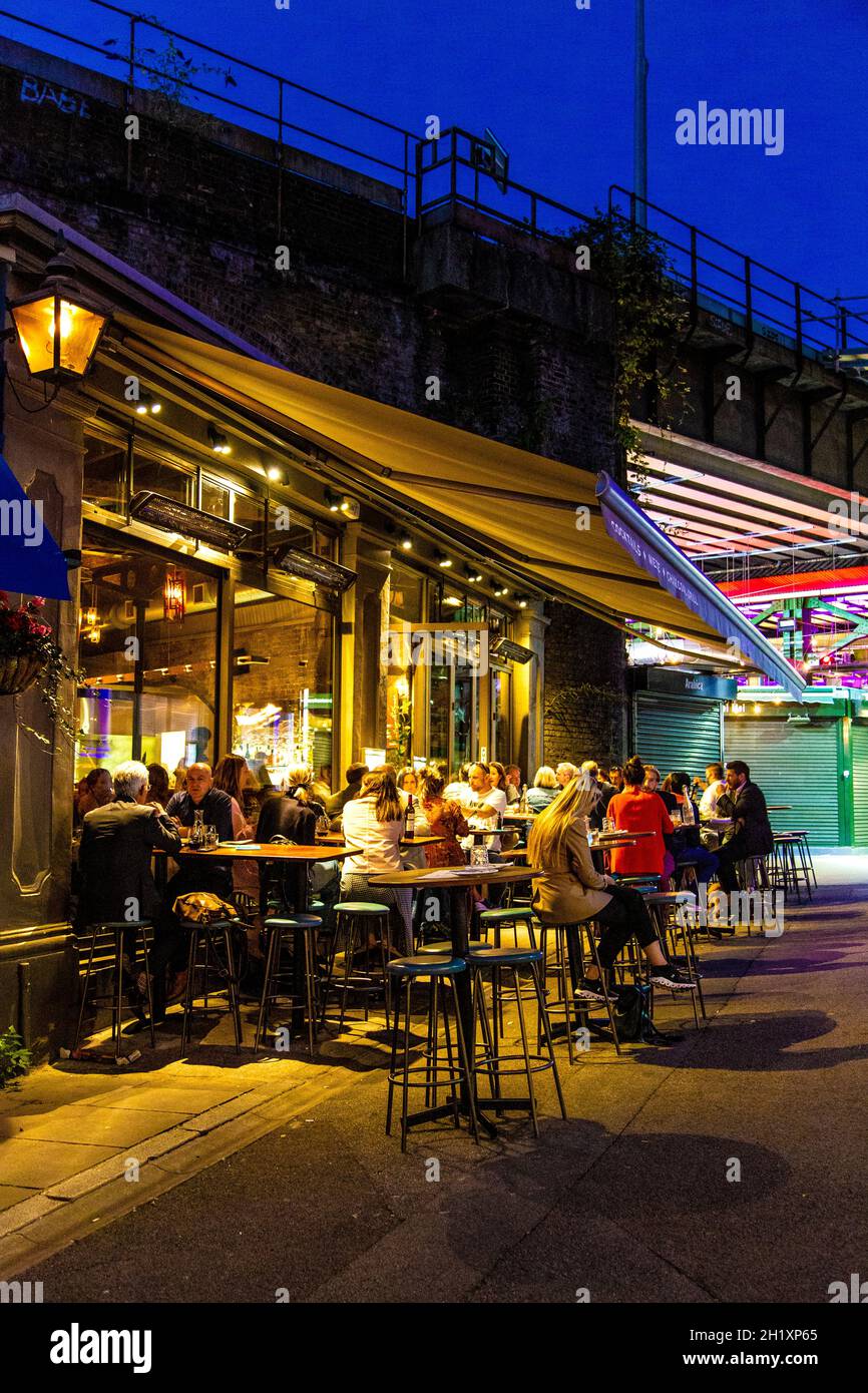 People dining al fresco at night at Arabica Restaurant in Borough Market, London Bridge, London, UK Stock Photo