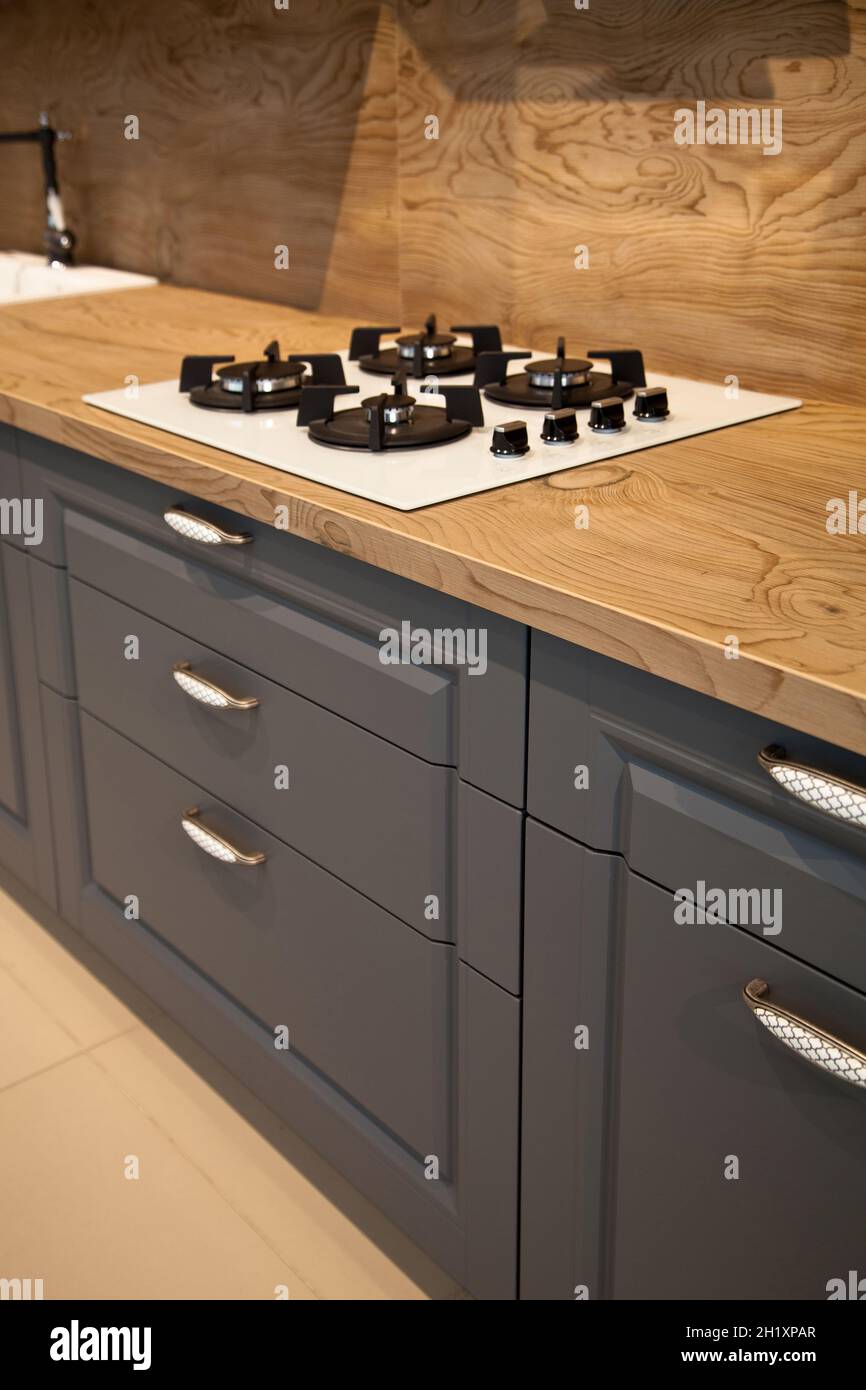 https://c8.alamy.com/comp/2H1XPAR/interior-of-luxurious-wooden-modern-kitchen-equipment-and-grey-cabinets-2H1XPAR.jpg