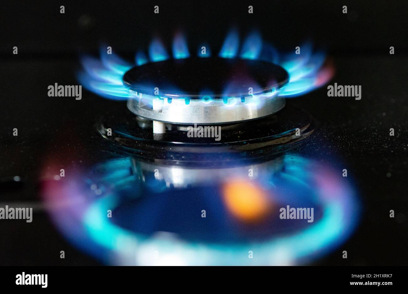 A lit gas ring on a cooker, Cumbria, UK. Stock Photo