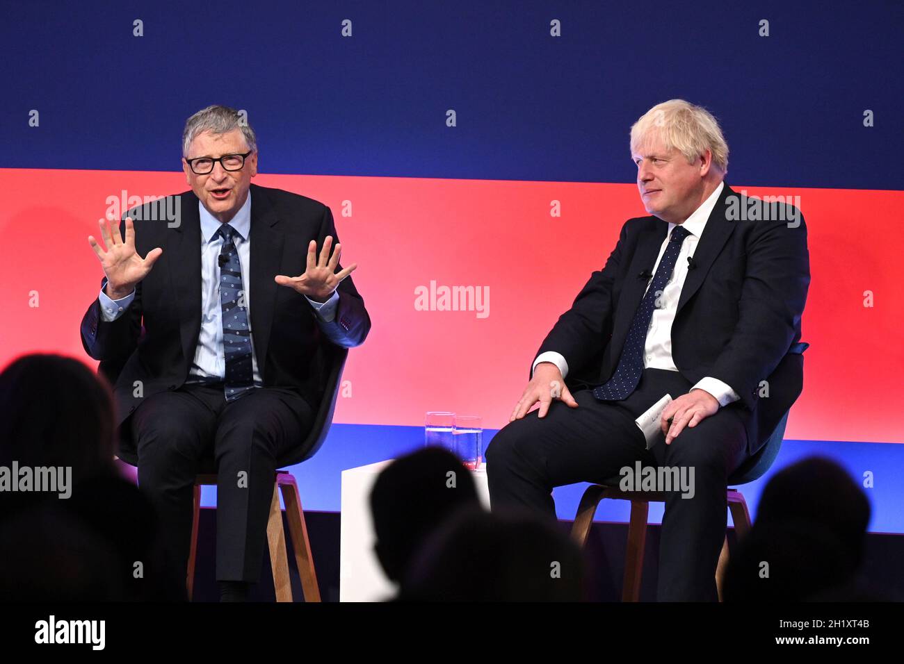 Prime Minister Boris Johnson (right) appears on stage in conversation with American Businessman Bill Gates during the Global Investment Summit at the Science Museum, London. Picture date: Tuesday October 19, 2021. Stock Photo