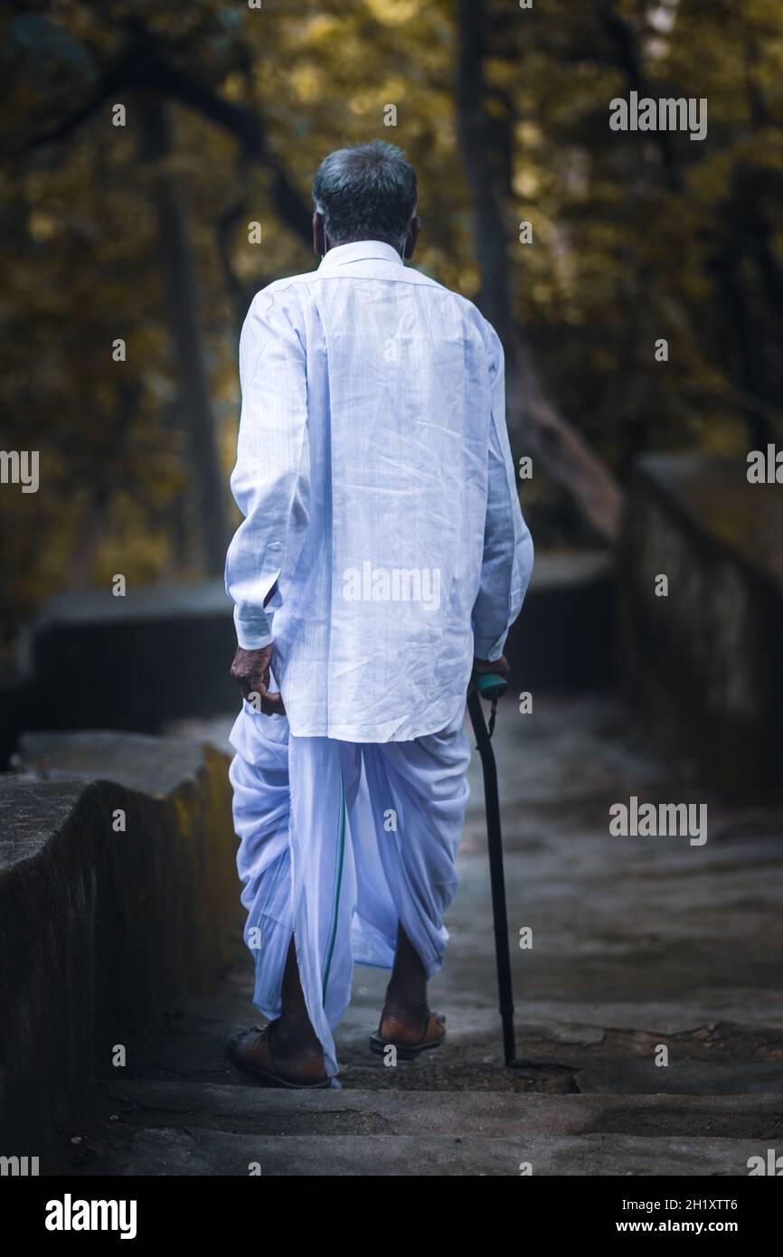 Back view of a lonely senior male with a walking stick Stock Photo - Alamy