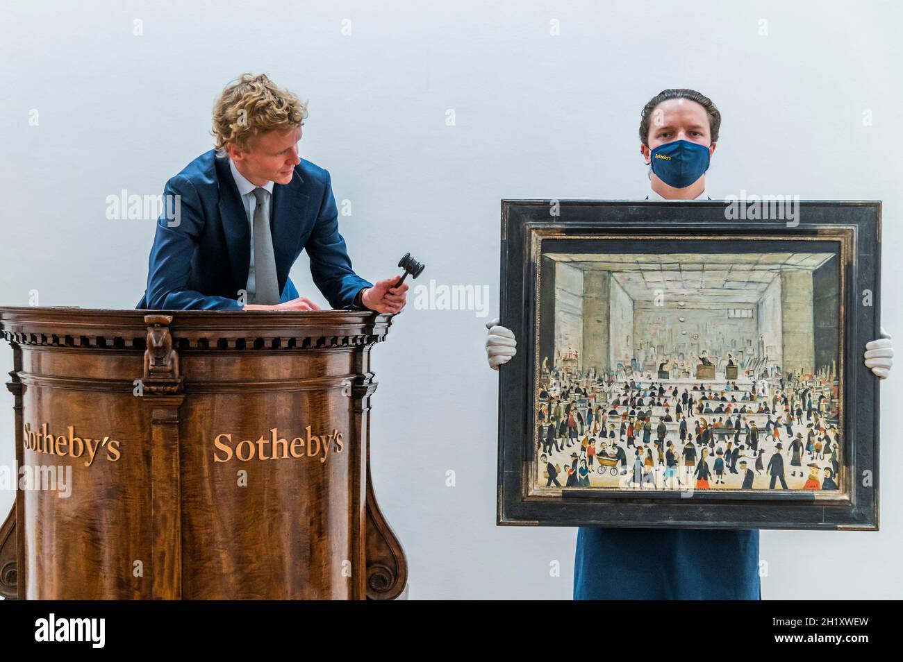 London, UK. 19th Oct, 2021. L.S. Lowry ‘The Auction' - The Artist's Only Known Painting of an Auction Room makes its Auction Debut at Sotheby's London this November, with an Estimate of £1.2 - 1.8 Million. Credit: Guy Bell/Alamy Live News Stock Photo