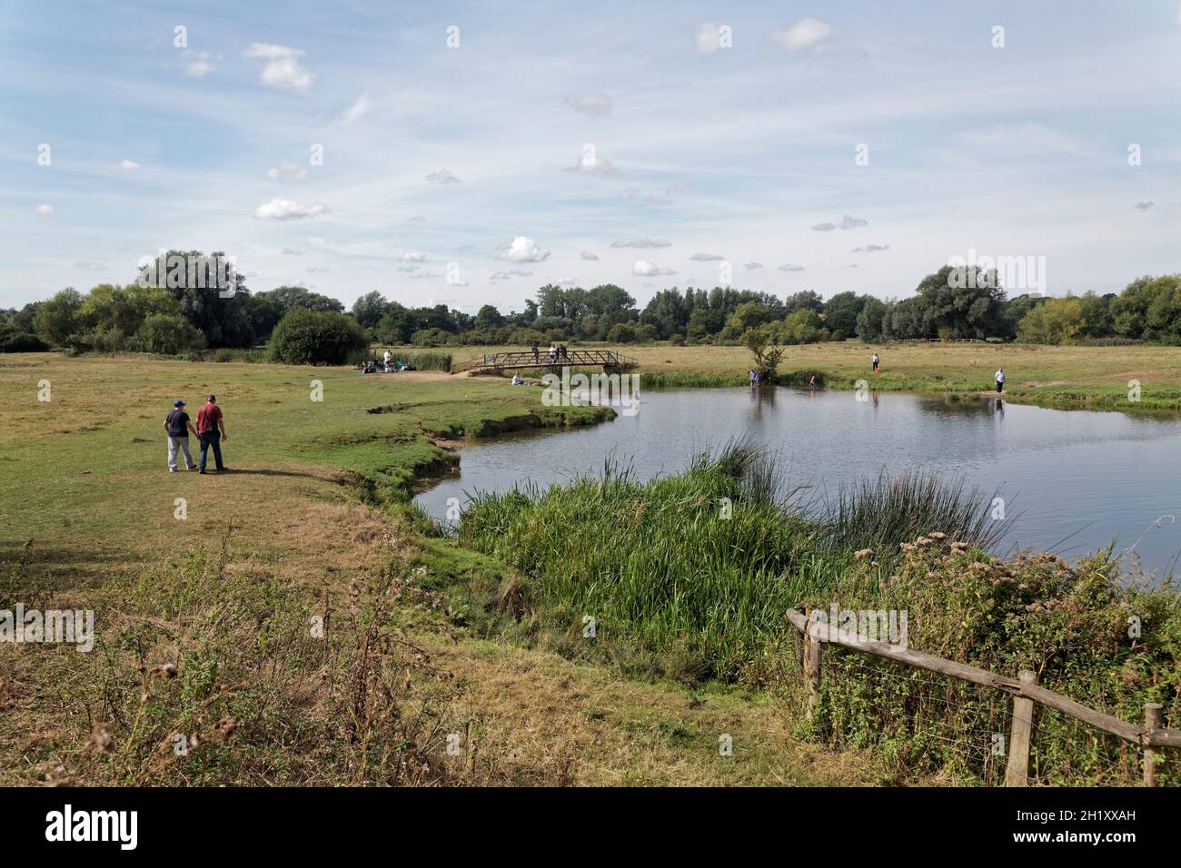 People walking by the river Stour on Sudbury meadows, Suffolk, England