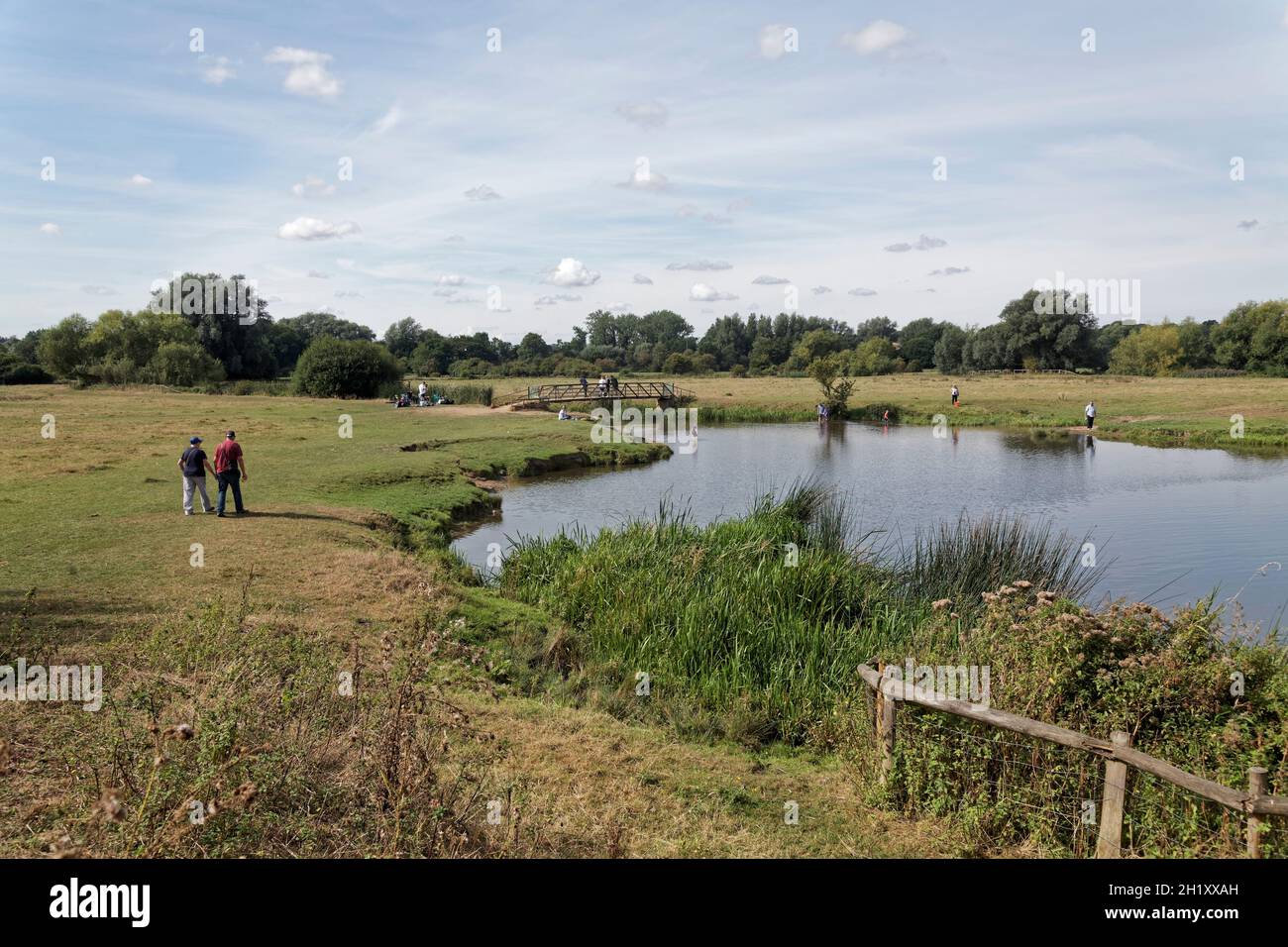 People walking by the river Stour on Sudbury meadows, Suffolk, England. Stock Photo