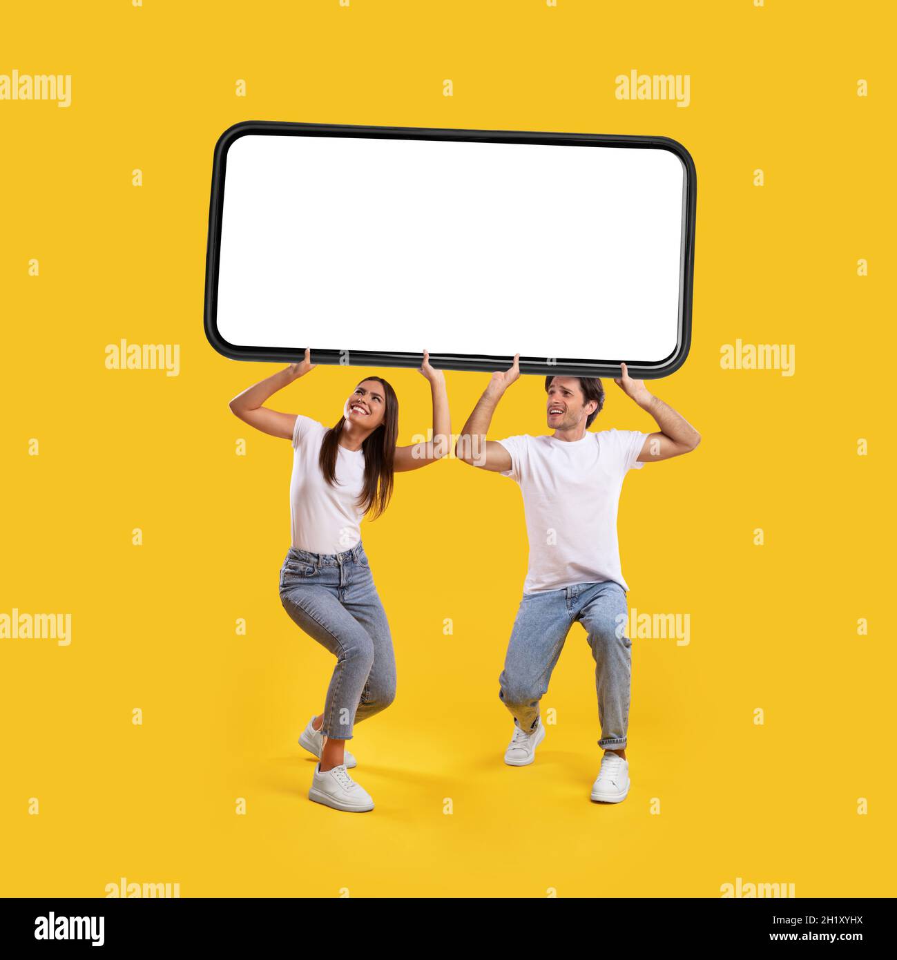 Couple holding heavy white empty smartphone screen Stock Photo