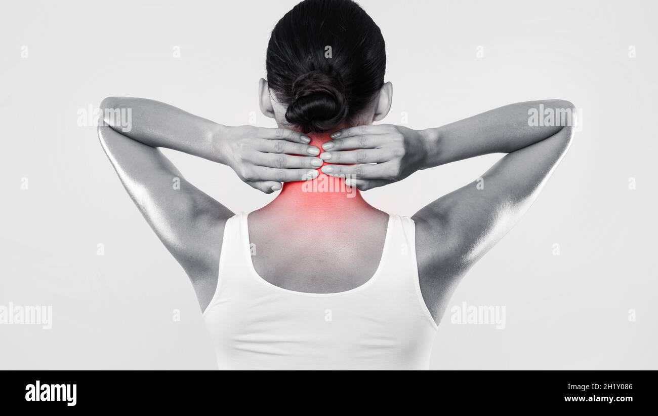 Back view of unrecognizable woman touching and massaging her neck Stock ...