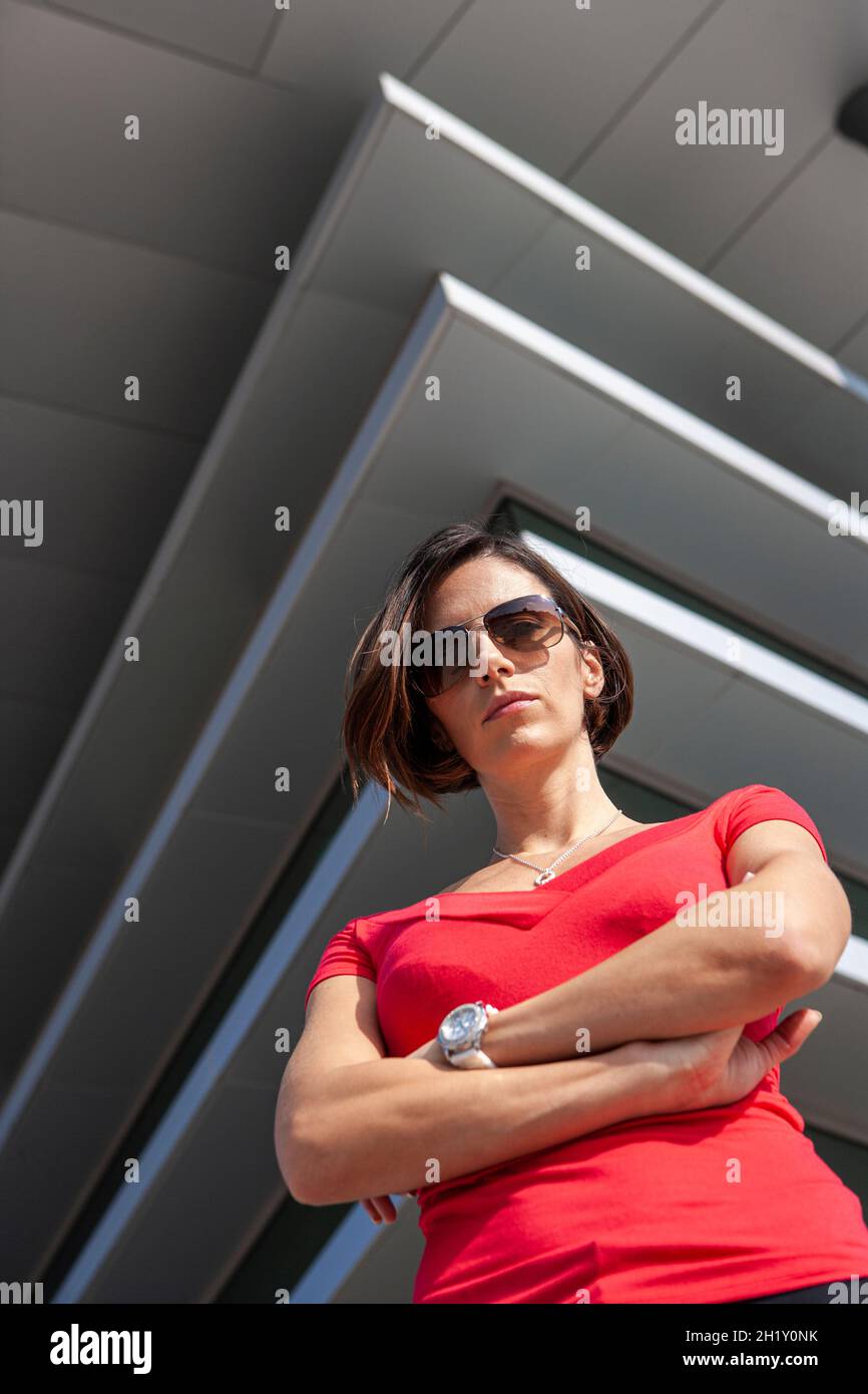 Confident businesswoman standing outside her office building Stock Photo