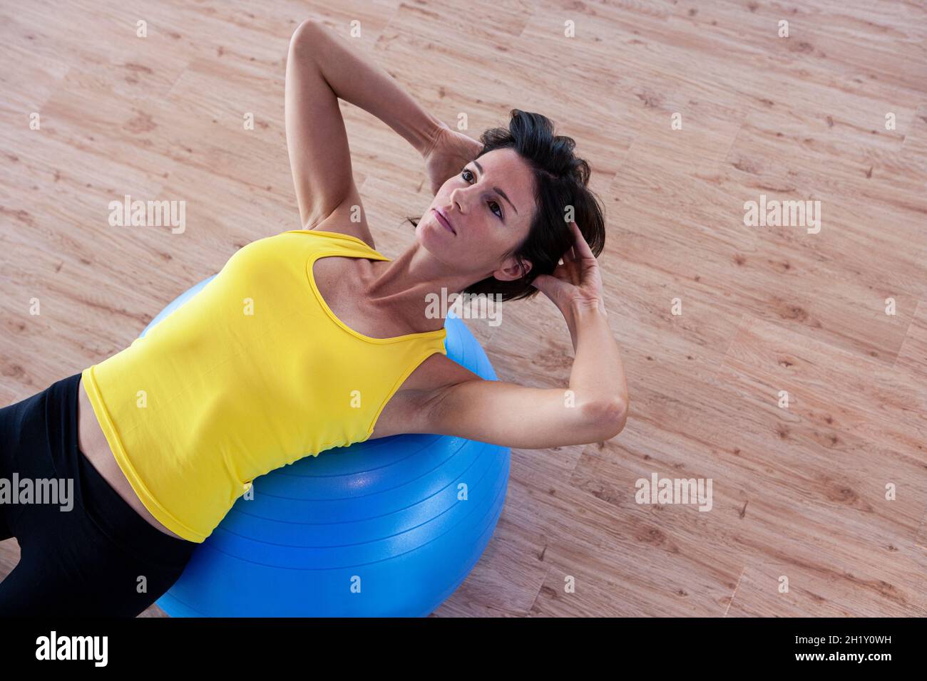 Healthy young woman working out in a gym Stock Photo