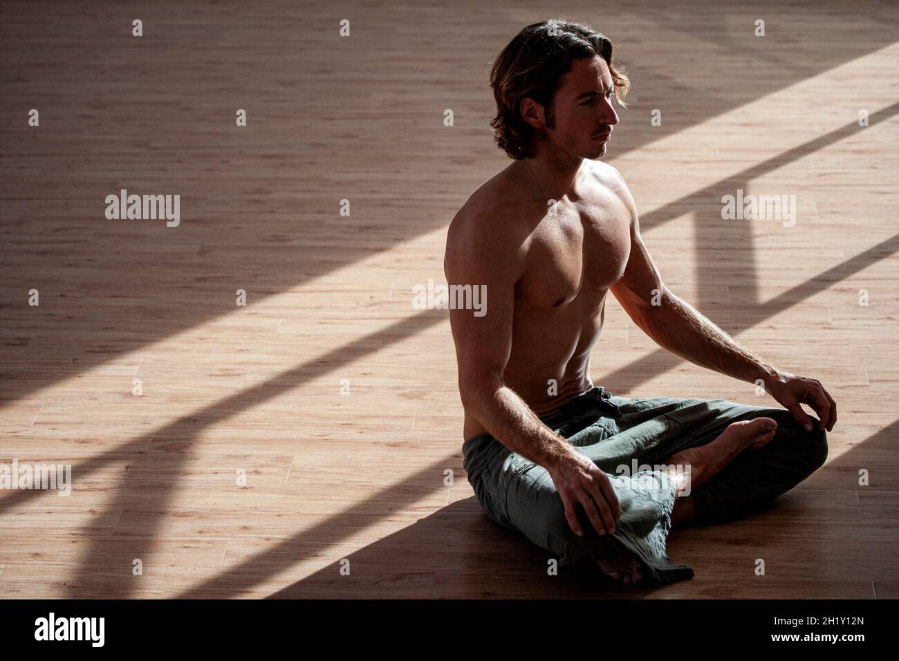 Man doing yoga at the gym Stock Photo