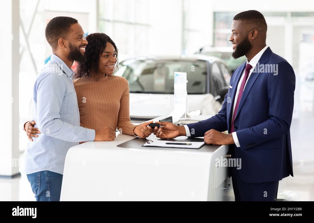 Purchasing Car Happy Black Couple Key From Manager In Dealership Purchasing Car Happy Black Couple Key From Manager In Dealership