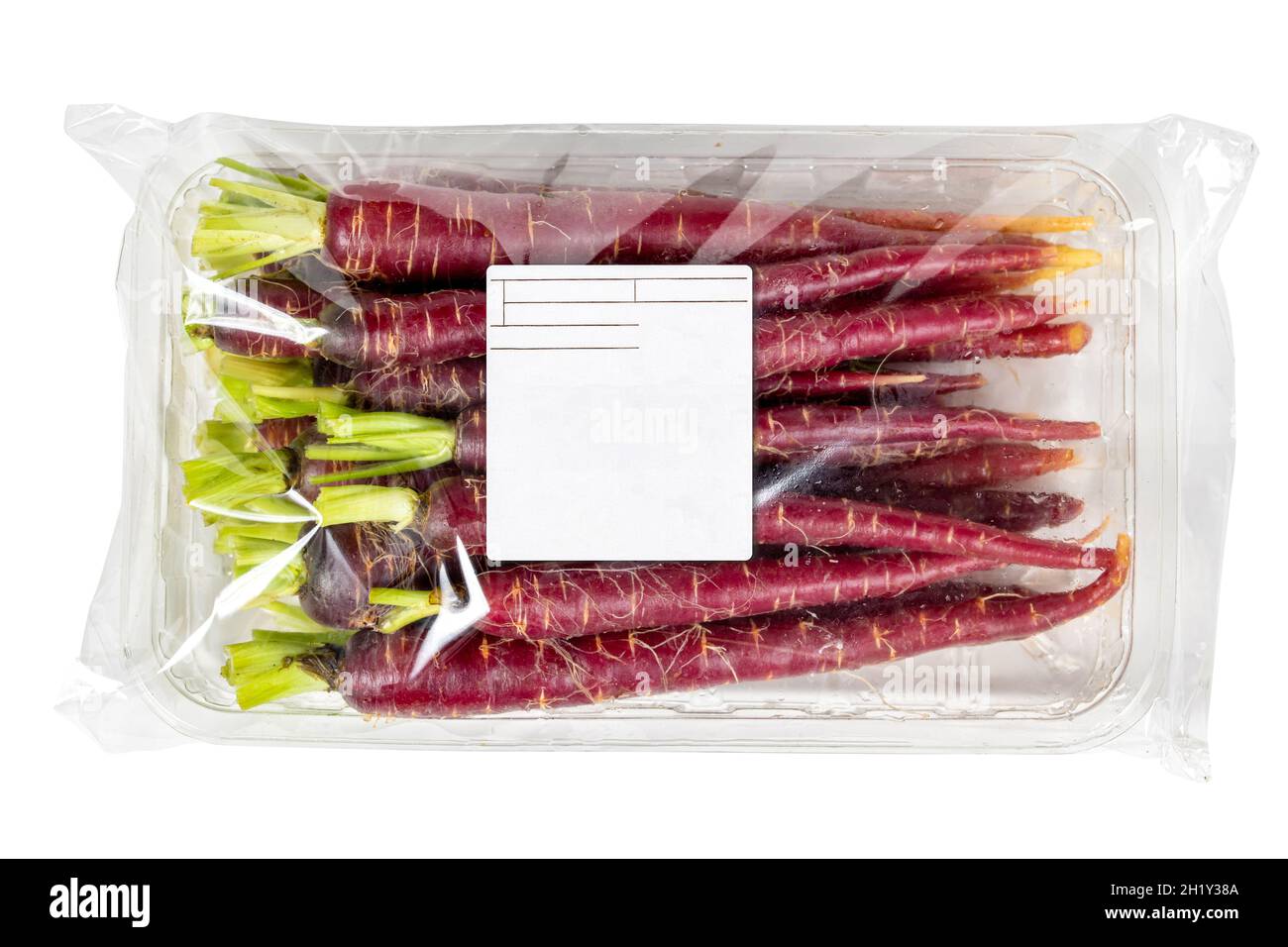 Mini red carrots in labeled packaging on a white background Stock Photo