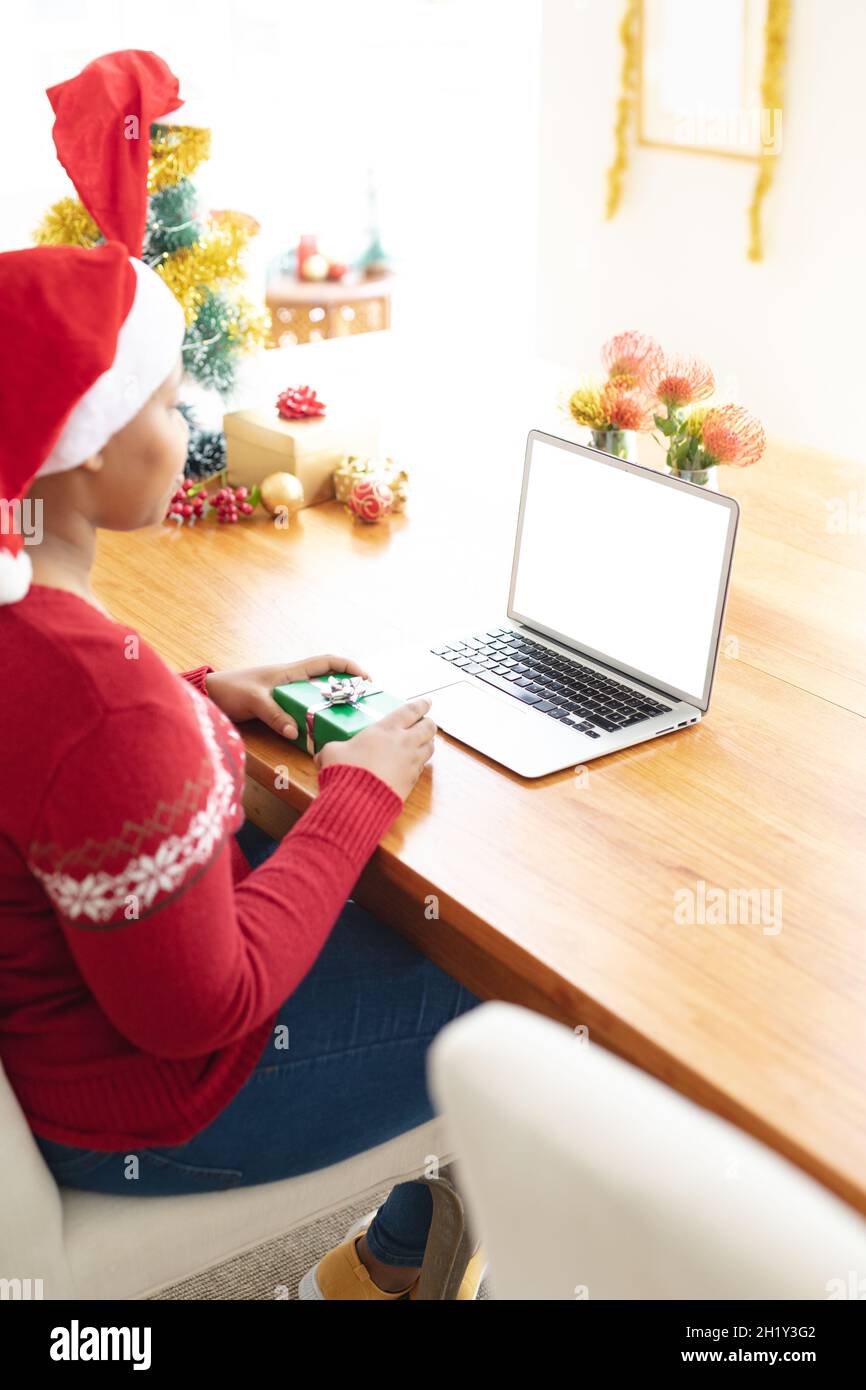 Happy african american plus size woman making christmas video call on laptop with copy space Stock Photo