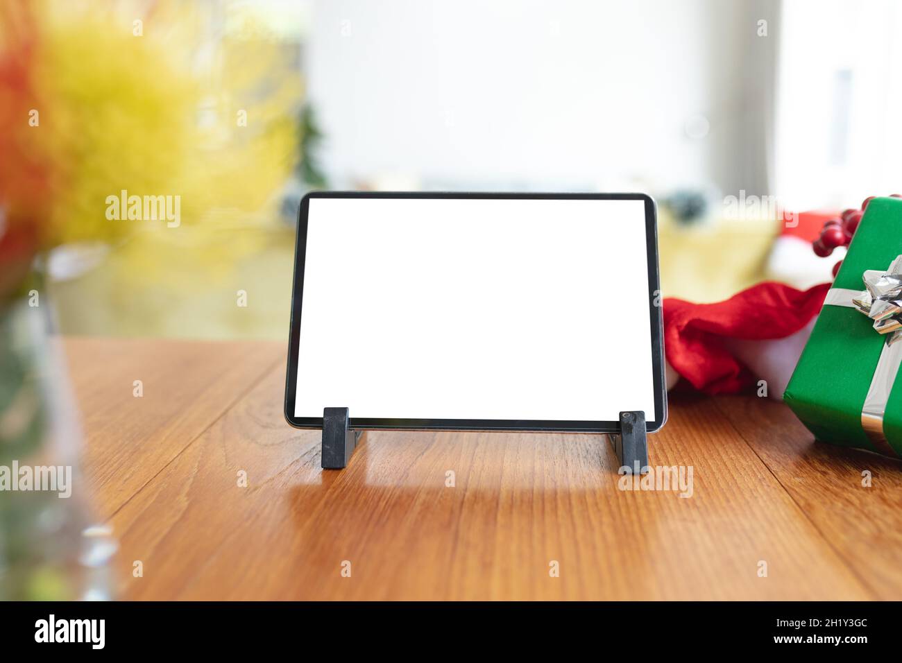 Tablet with copy space on screen lying on table with christmas decorations Stock Photo