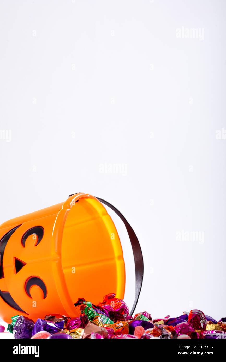 Composition of halloween bucket with trick or treat sweets on white background Stock Photo
