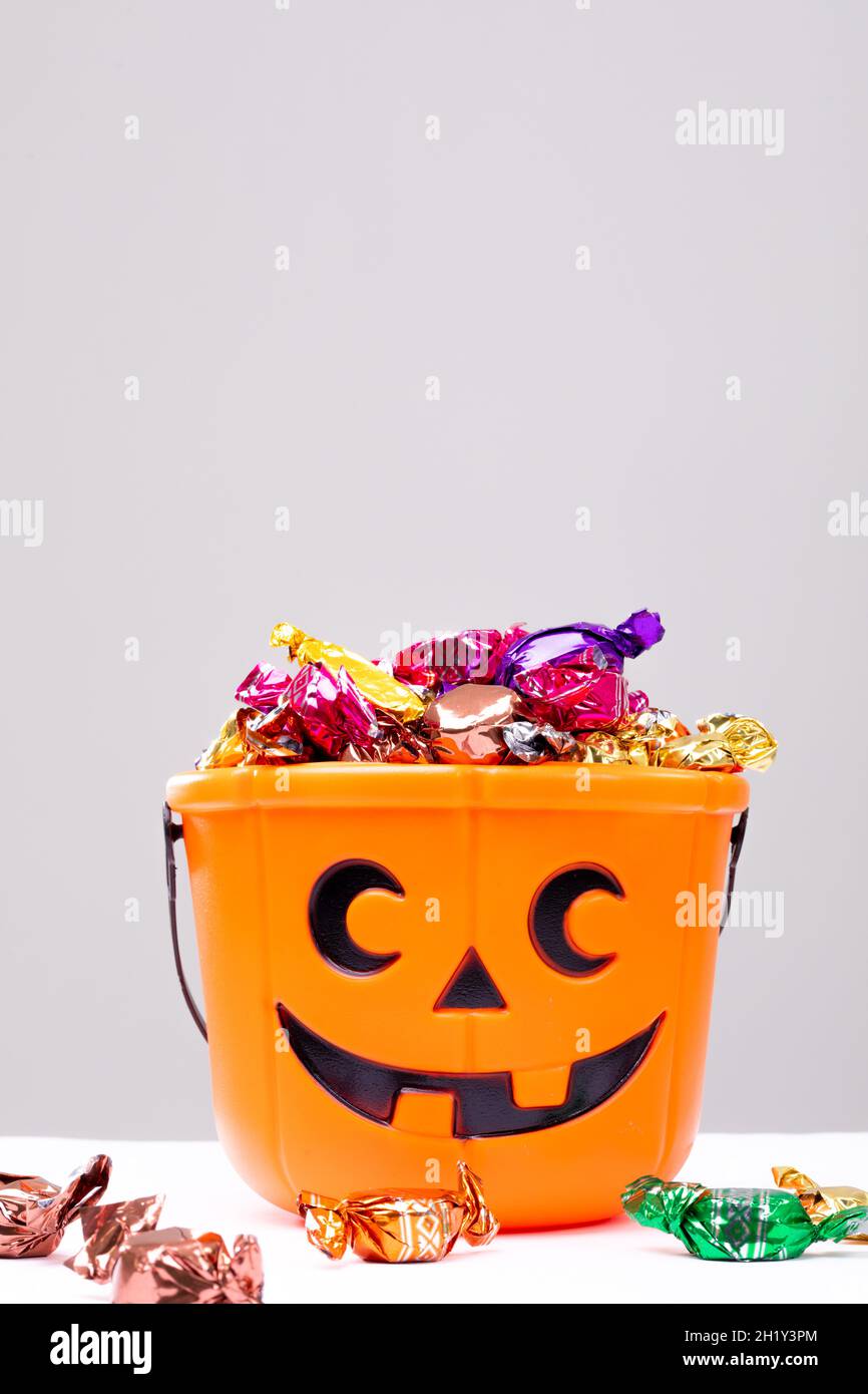 Composition of halloween bucket with trick or treat sweets on white background Stock Photo