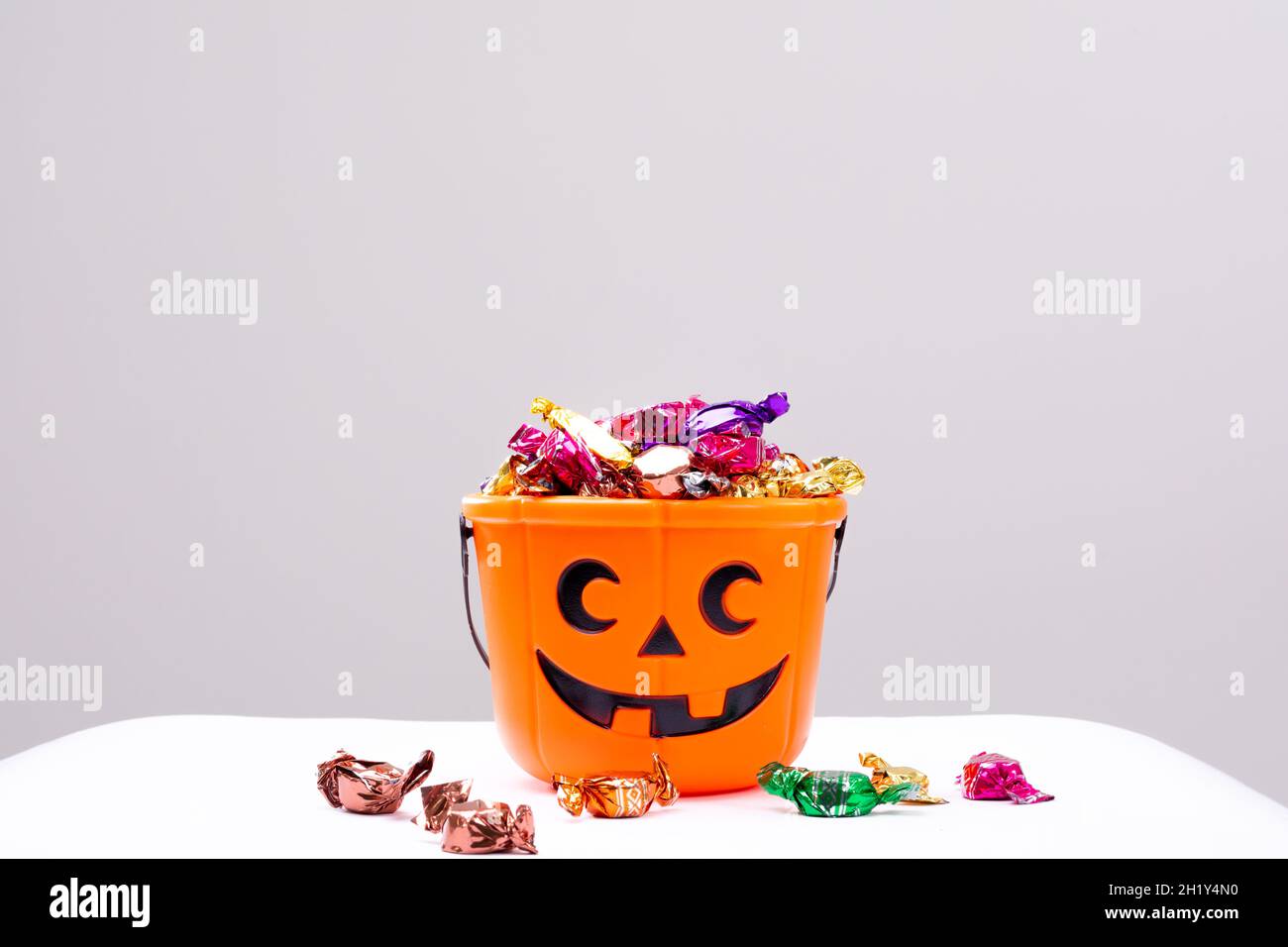 Composition of halloween bucket with trick or treat sweets on white background Stock Photo