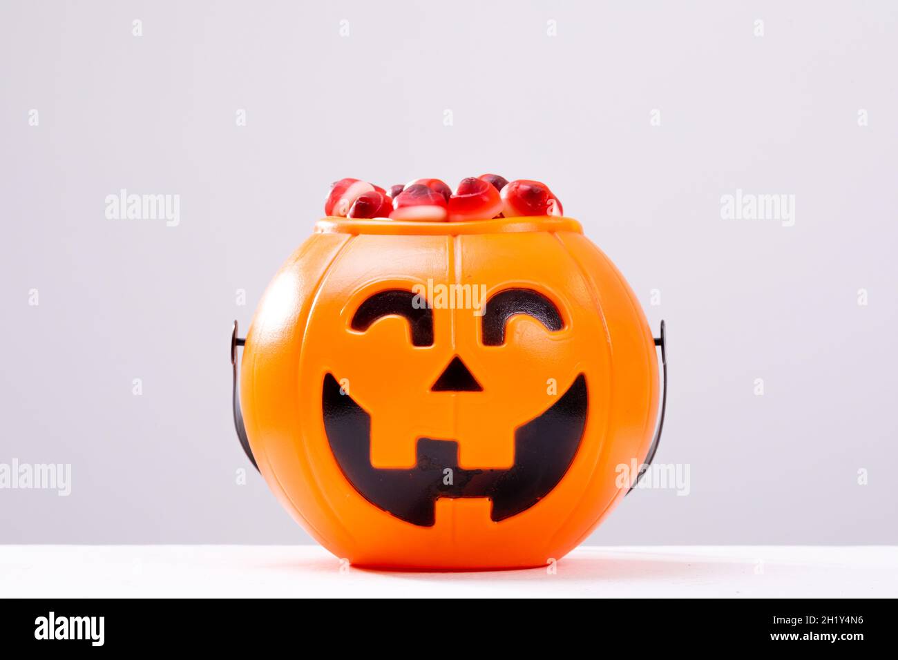 Composition of halloween bucket with trick or treat sweets on white background Stock Photo