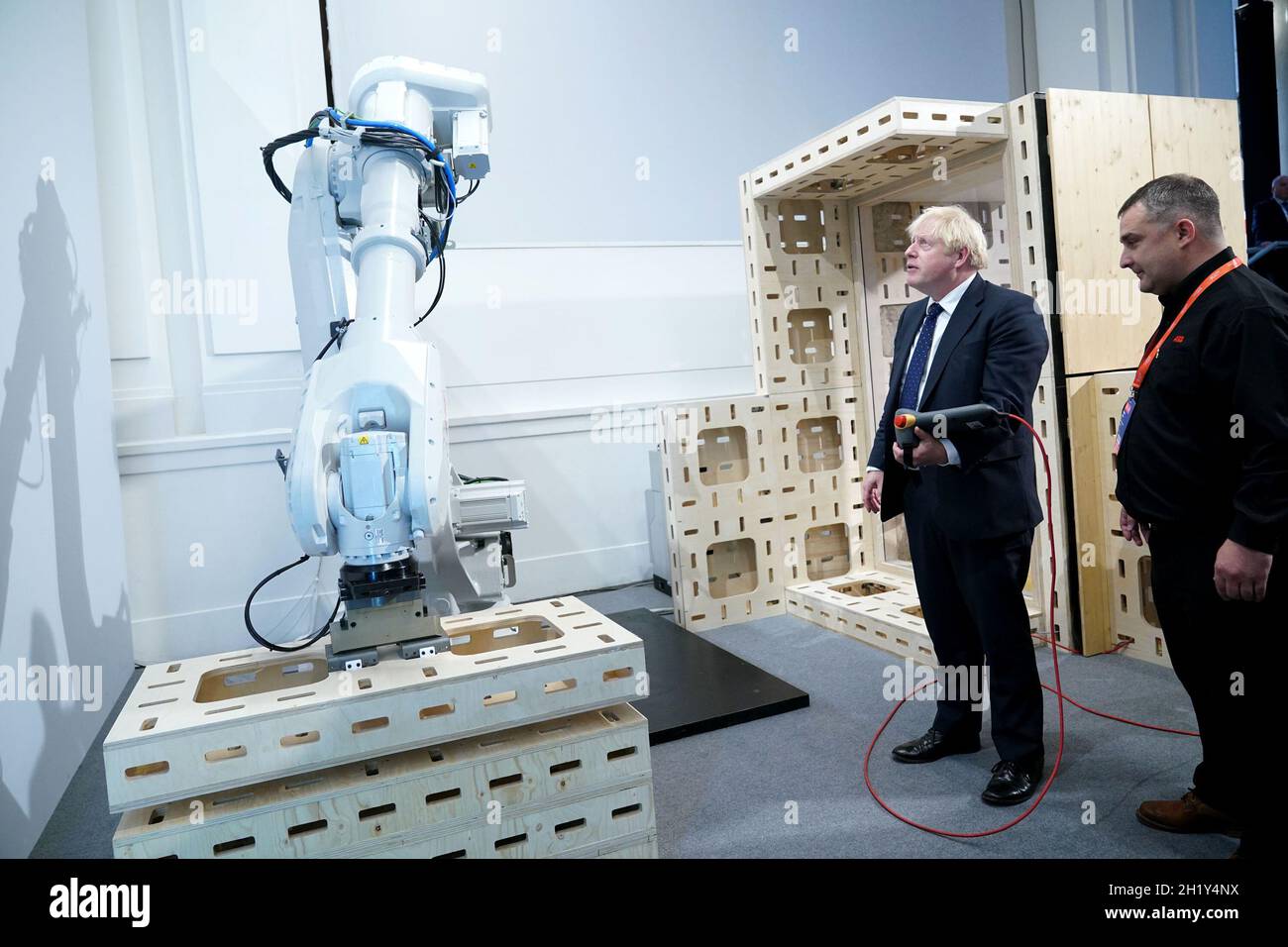 Prime Minister Boris Johnson operating a robot arm at the Auar (Automated Architectire) stand during a visit to the Innovation Zone of the Global Investment Summit at the Science Museum, London. Picture date: Tuesday October 19, 2021. Stock Photo