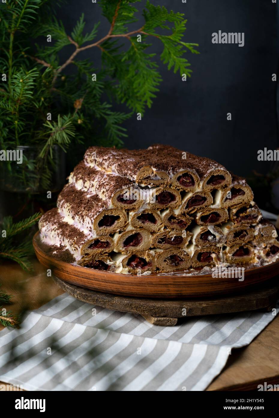 Monastic hut pie. Homemade cakes, sweet cake with cherry filling and cream. Collected from tubes, dough is rolled. Cake on the table. Festive food for dessert Stock Photo