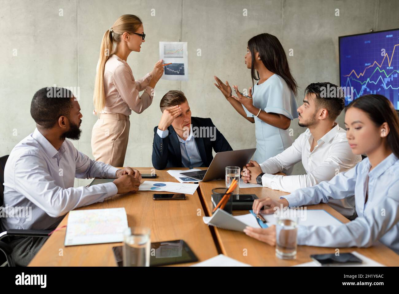 Business Conflicts. Two Female Employees Arguing During Corporate Meeting In Office Stock Photo