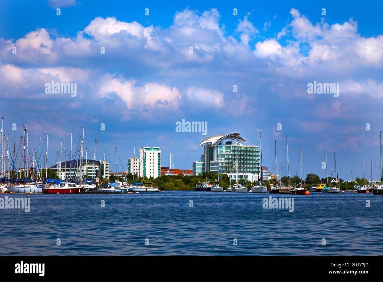 Cardiff Bay from the sea with St David's hotel & boats moored blue sky with clouds tinged with pink copy space Wales UK Stock Photo