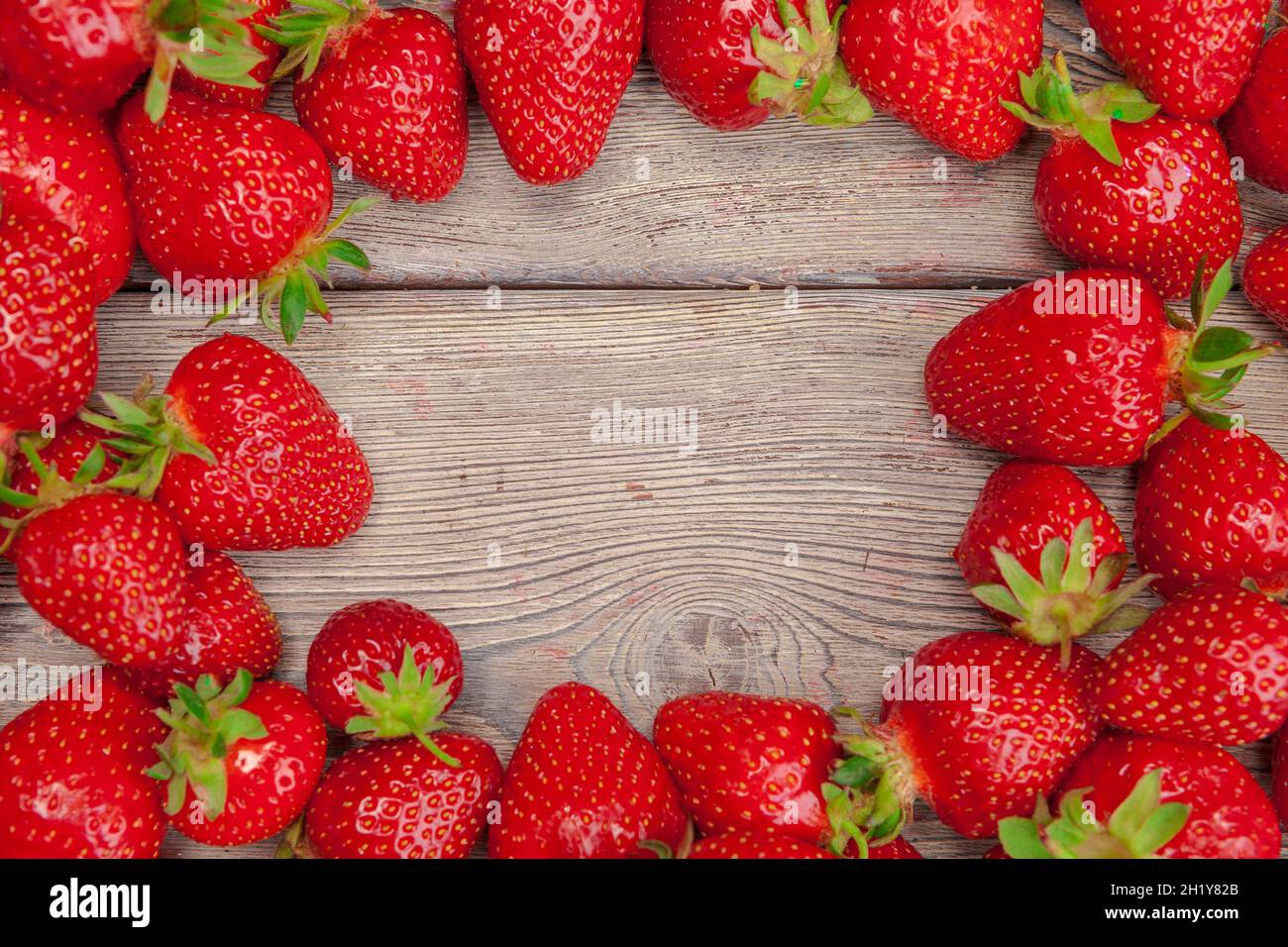 Red ripe strawberries on wooden table close up Stock Photo - Alamy