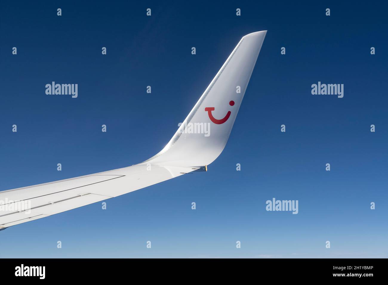 Wing with winglet and logo of TUIfly in front of blue sky Stock Photo