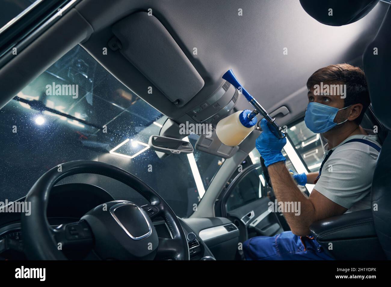 Dry cleaning of automobile ceiling by car service specialist Stock Photo Alamy