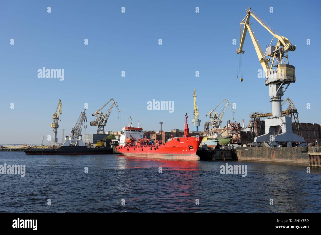 Cargo ship under uploading in the port of St. Petersburg, Russia Stock Photo